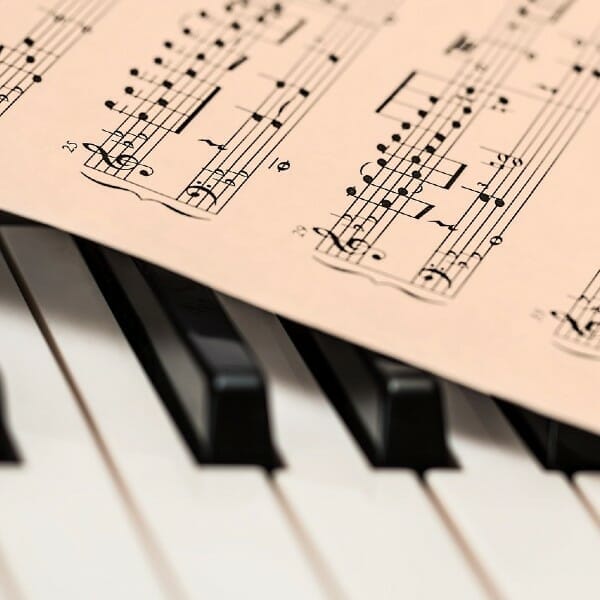 Musical score on piano keys.