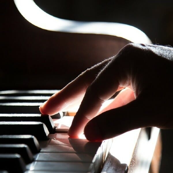 Right hand playing piano keys. Free images and free photos.