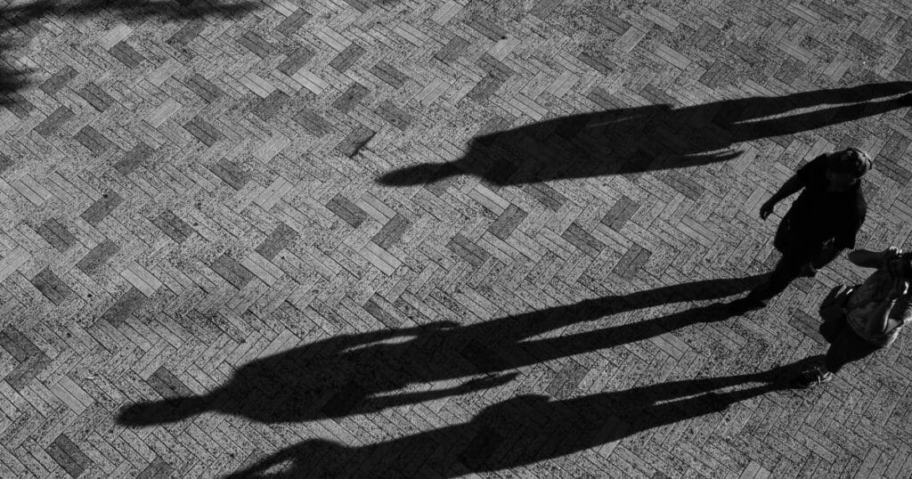 Long shadows across the herringbone pattern of the pavement on the Navy Pier in Chicago.