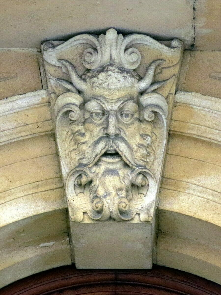 A keystone face above a rounded arch window, on the old Bristol Stock Exchange building (1903), Bristol, England.