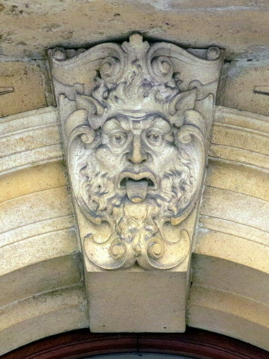 Another keystone face at the apex of a rounded arch window, at the old Bristol Stock Exchange buildings (1903), Bristol, England.