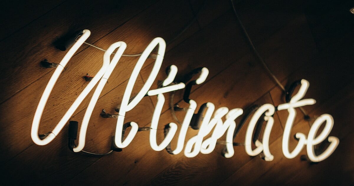 A neon light spells out the word - Ultimate. What Are the Ultimate Questions in Life?